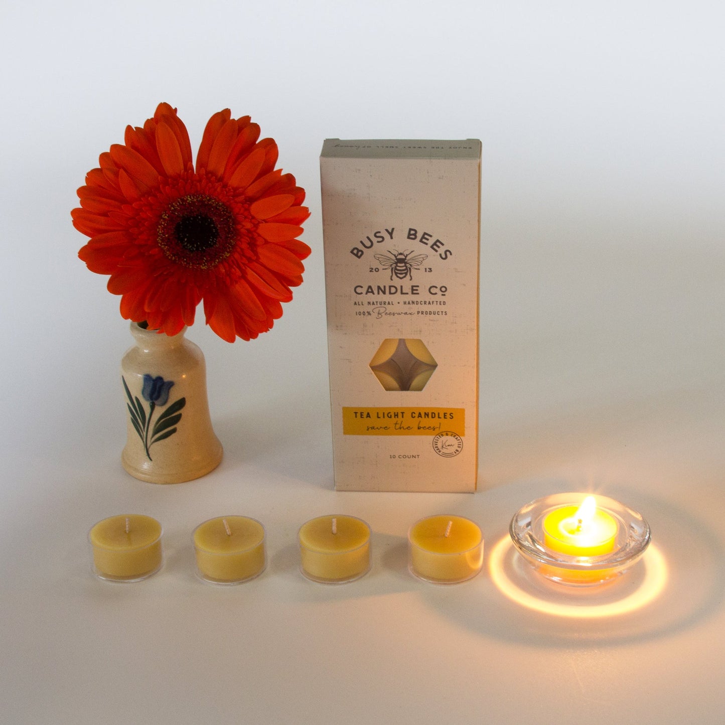 Lit tealight candle with unlit tealight candles